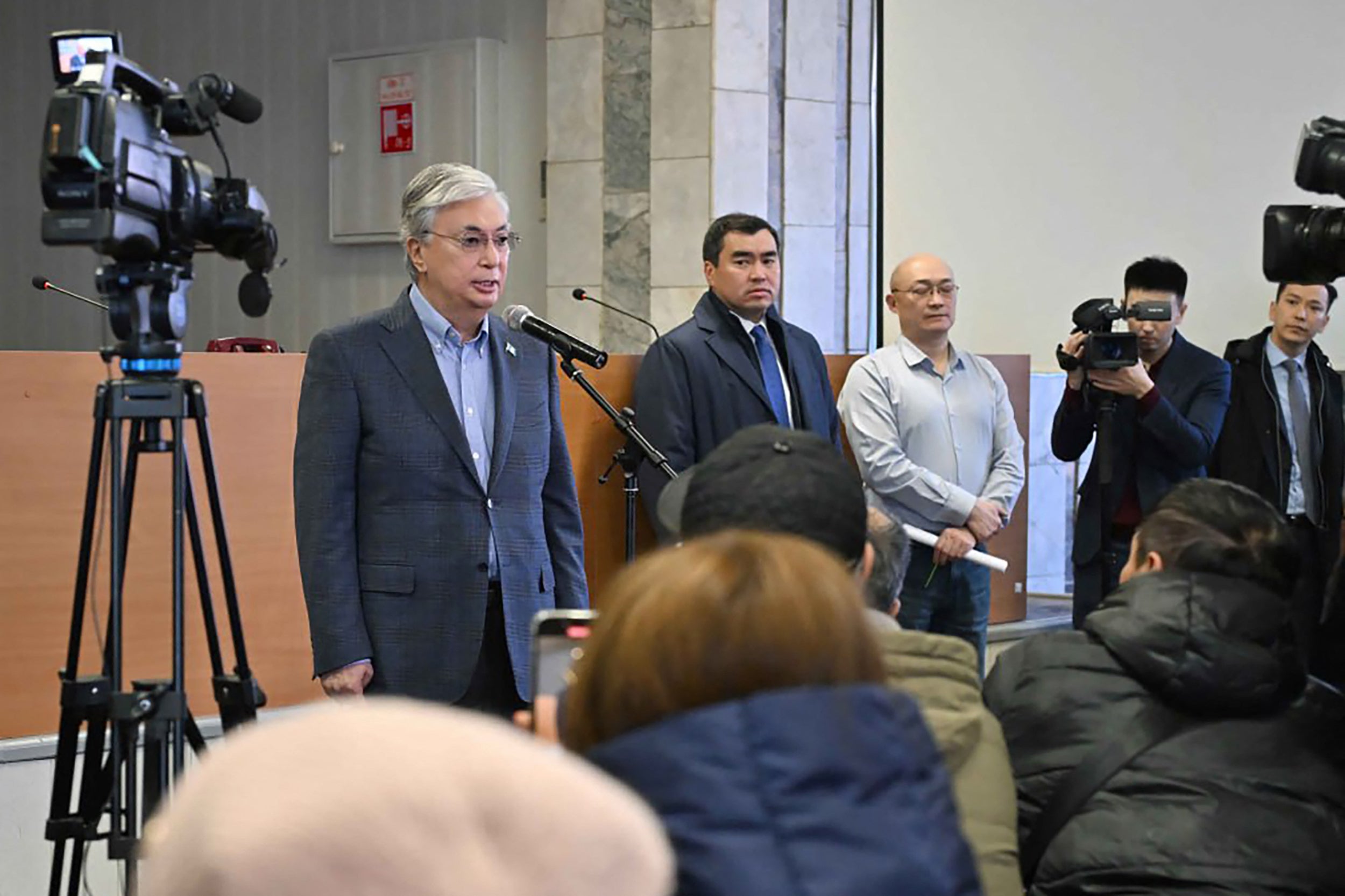 Kazakhstan's President Kassym-Jomart Tokayev (L) speaking with employees and relatives of miners at the Kostenko coal mine in Karaganda