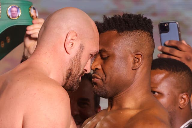 <p>Tyson Fury and Francis Ngannou go head to head during their weigh-in</p>