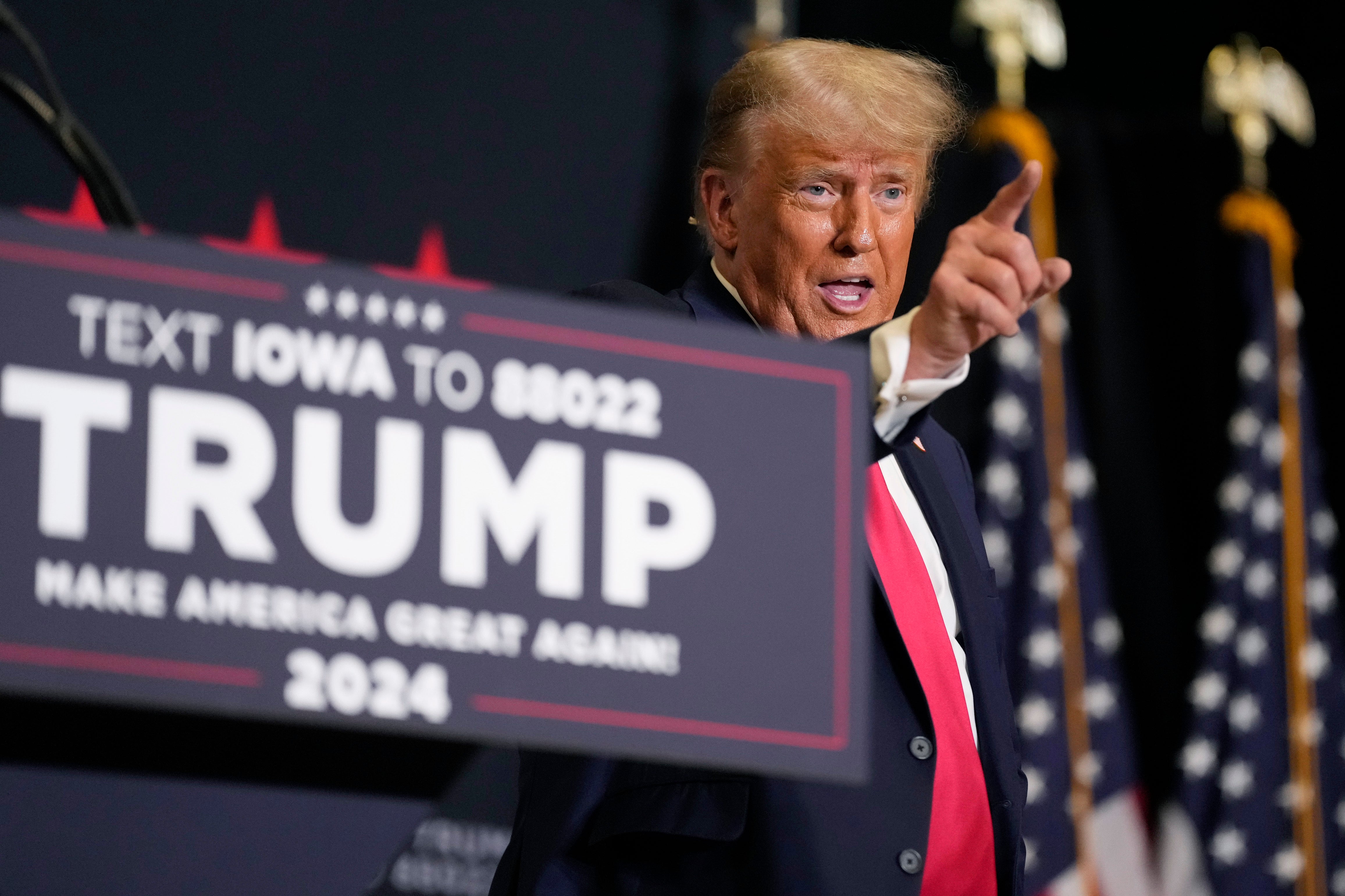 Former President Donald Trump points to the crowd as he leaves the stage after speaking at a campaign rally Monday, Oct. 16, 2023, in Clive, Iowa.