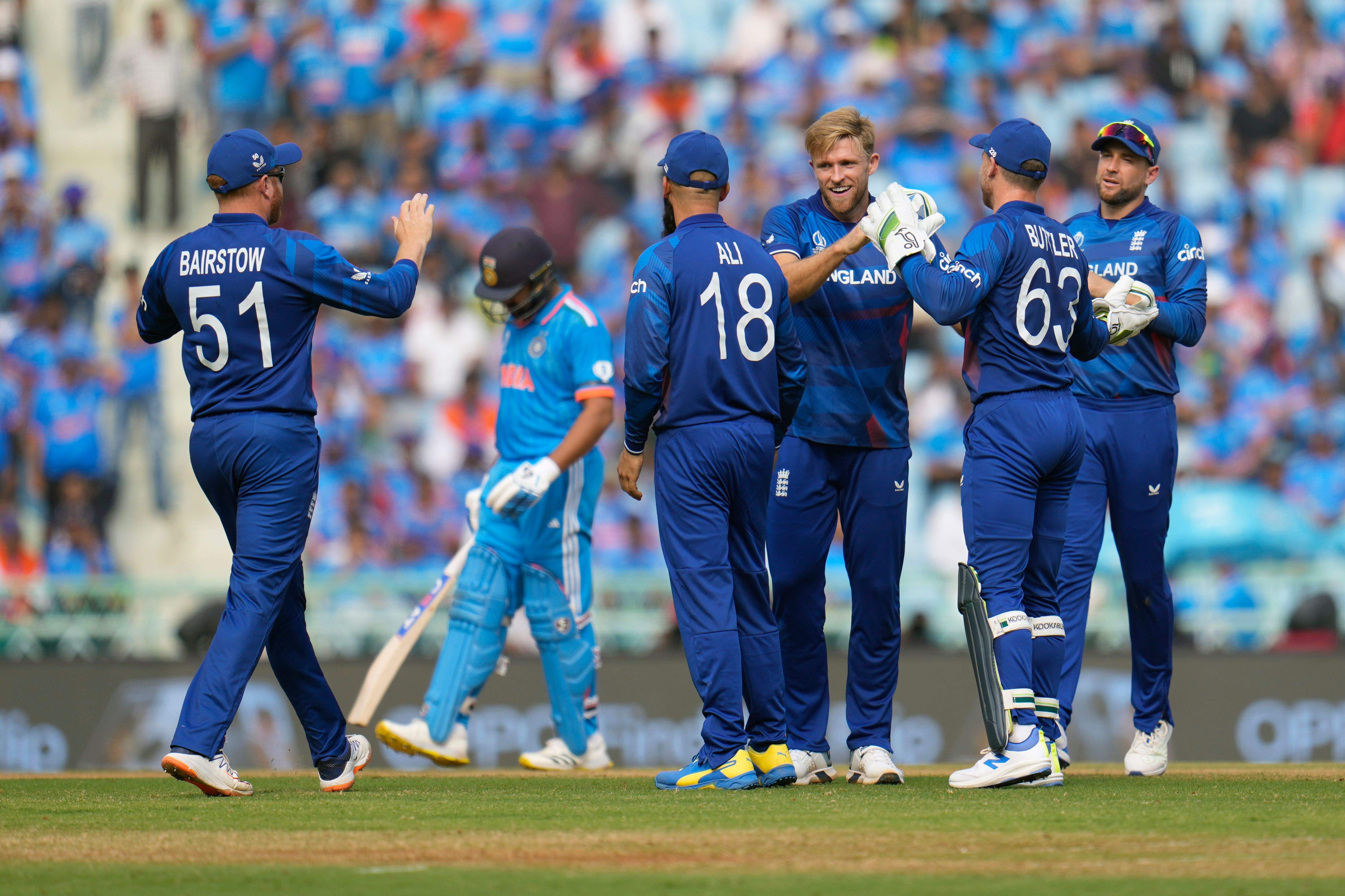 England’s David Willey (third from right) celebrates taking the wicket of India’s Virat Kohli (second from left) during the World Cup pool match in Lucknow (Aijaz Rahi/AP)