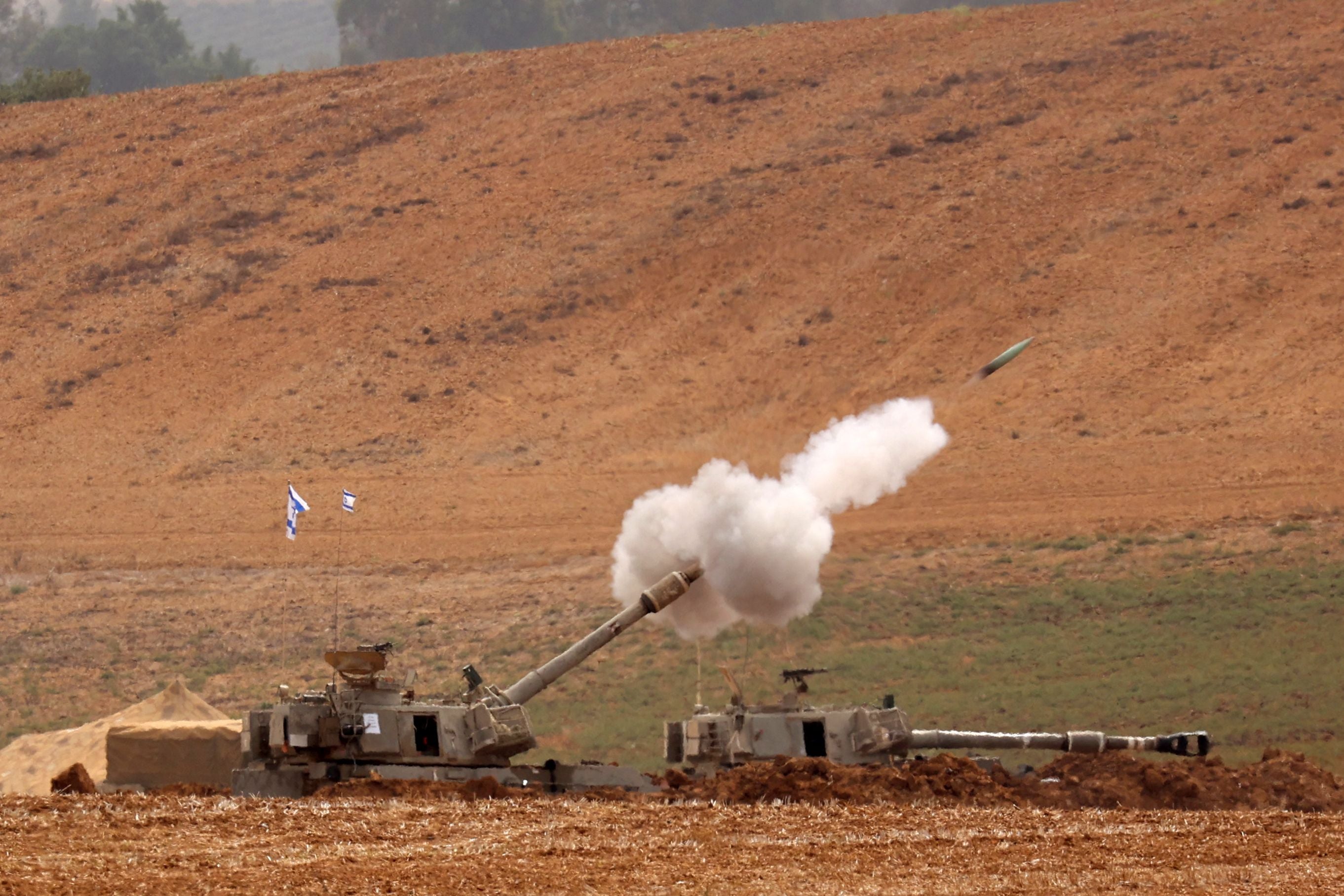 Artillery shells are fired from an undisclosed position toward the Gaza Strip by the Israeli army