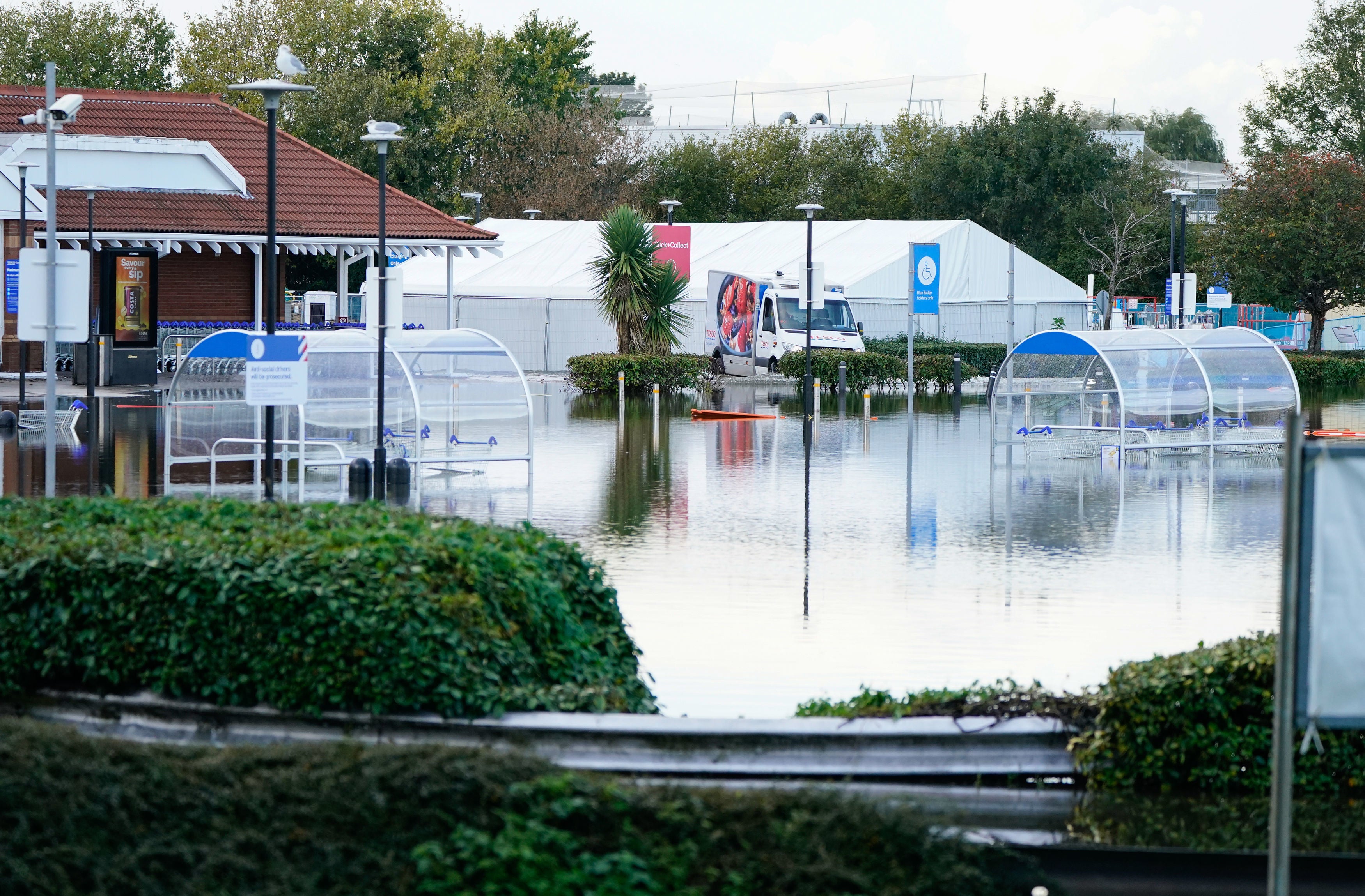 <p>A view of the flooded car park at a Tesco store in Bognor Regis after heavy rain the area. </p>