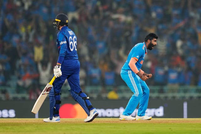 <p>India's Jasprit Bumrah, right, celebrates the wicket of England's Joe Root on 29 October </p>