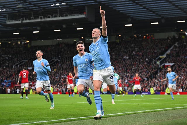 <p>Erling Haaland celebrates after opening the scoring from the penalty spot at Old Trafford </p>