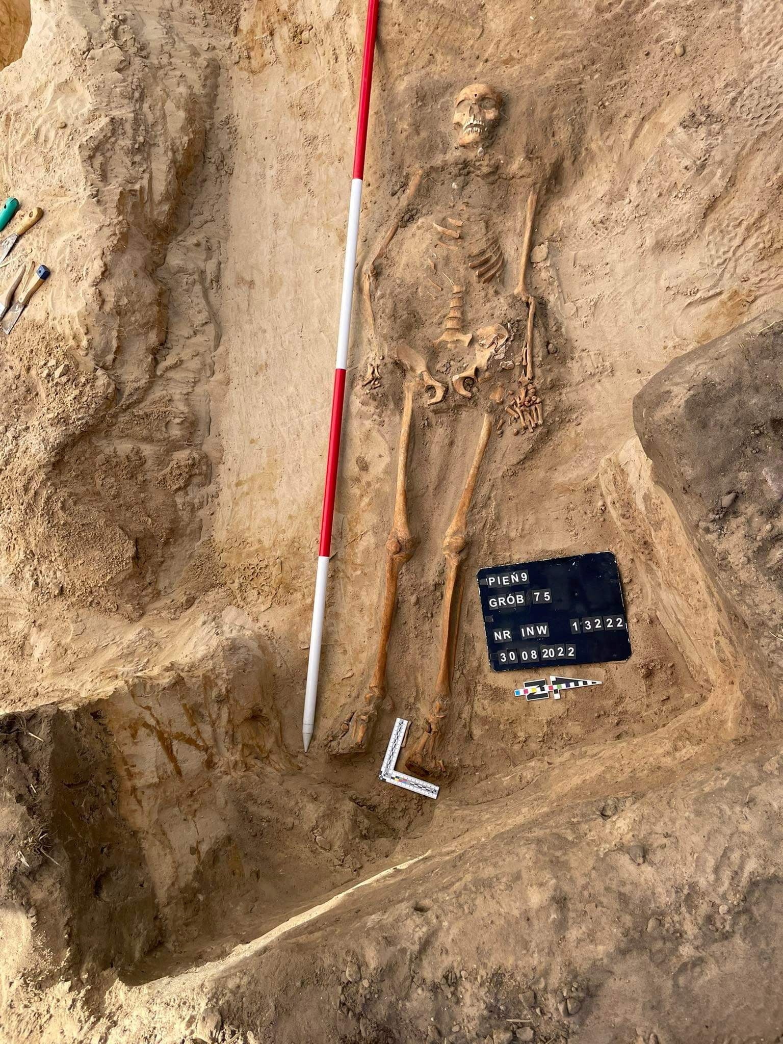 The skeleton of a young woman buried with a padlock on her foot and an iron sickle across her neck as a way of allegedly preventing her from rising from the dead, is seen in Pien