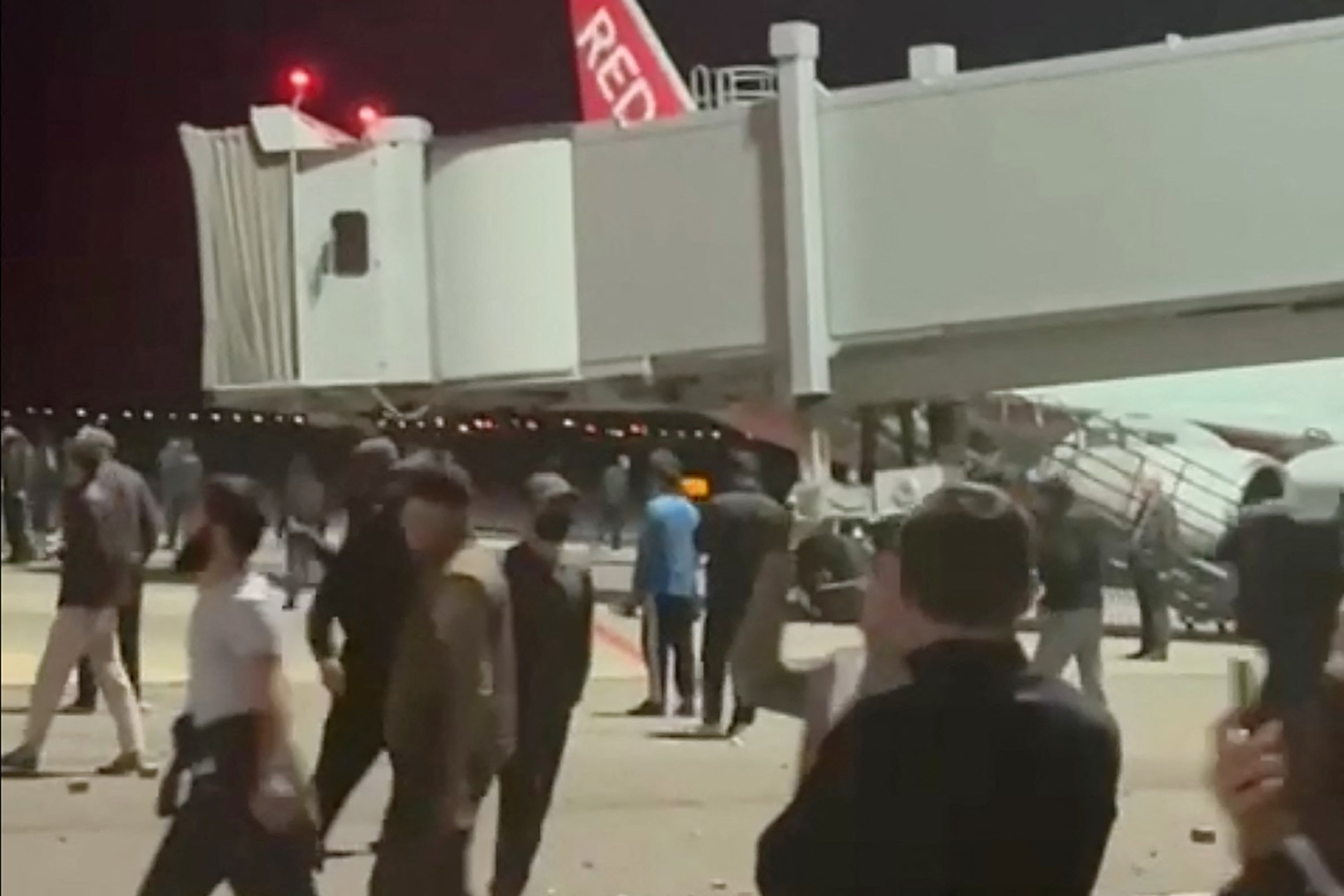 Rioters approach a Russian Red Wing plane believed to have arrived from Tel Aviv