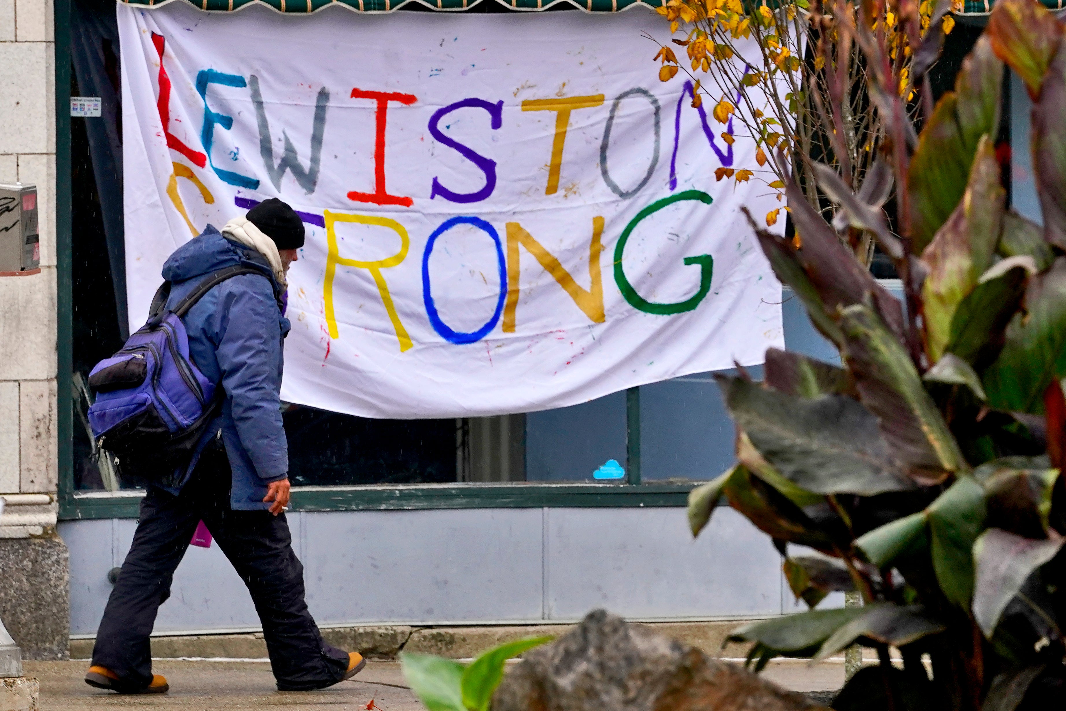 A man walks past a "Lewiston Strong" sign, Sunday, Oct. 29, 2023, in Lewiston, Maine