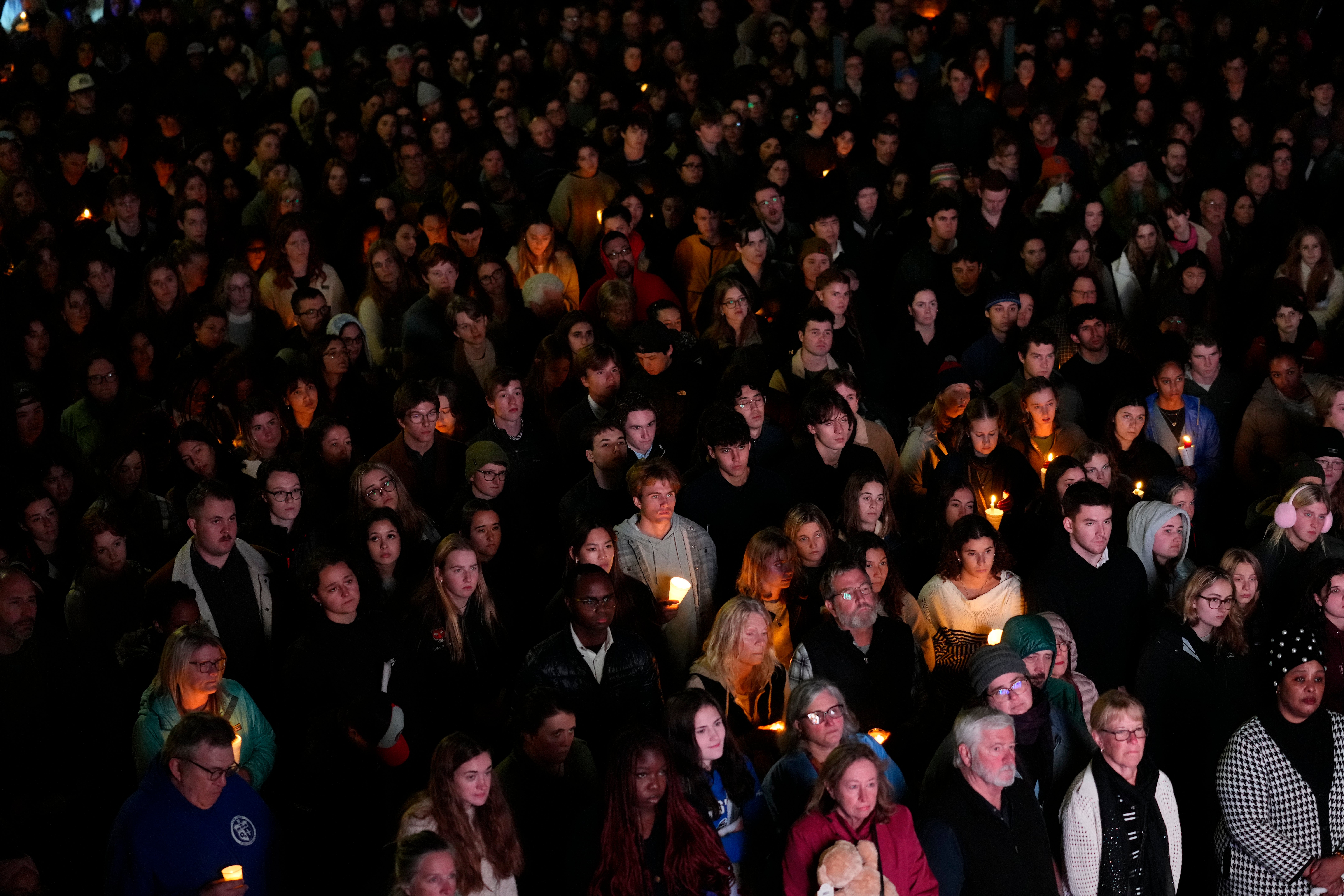 People gather at a vigil for the victims of the mass shootings