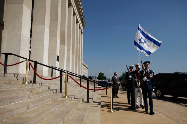 <p>A U.S. military honor guard carries the Israeli flag during a honor cordon for Israeli Defense Minister Ehud Barak at the Pentagon June 21, 2010 in Arlington, Virginia</p>