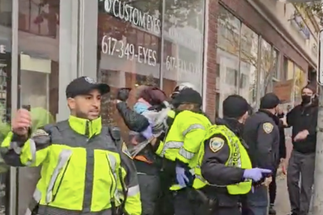 <p>Police are seen restraining a protestor outside the headquarters of Elbit Systems in Boston</p>
