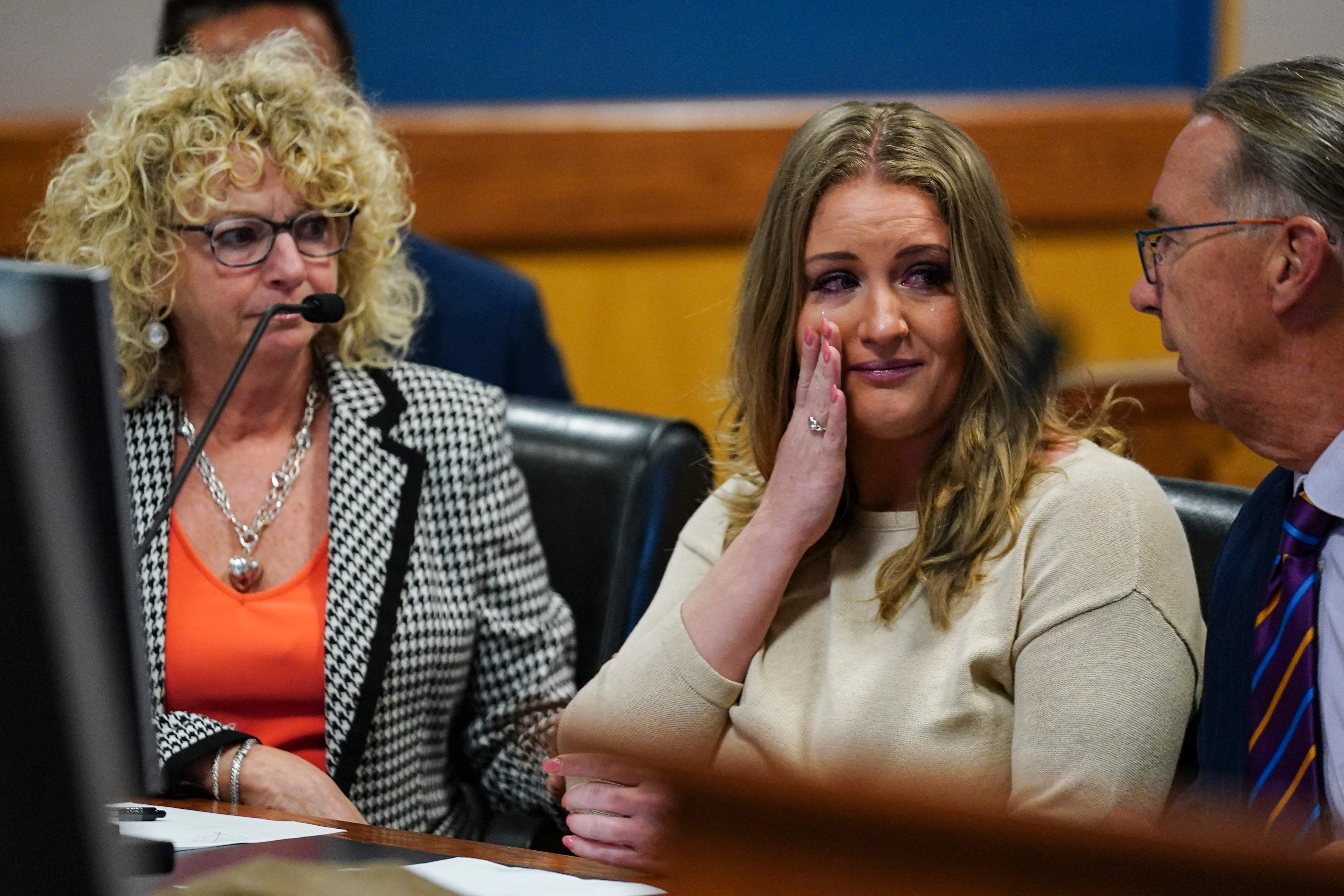 Jenna Ellis reacts with her lawyers after reading a statement pleading guilty to a felony connected to Georgia election interference case on 24 October