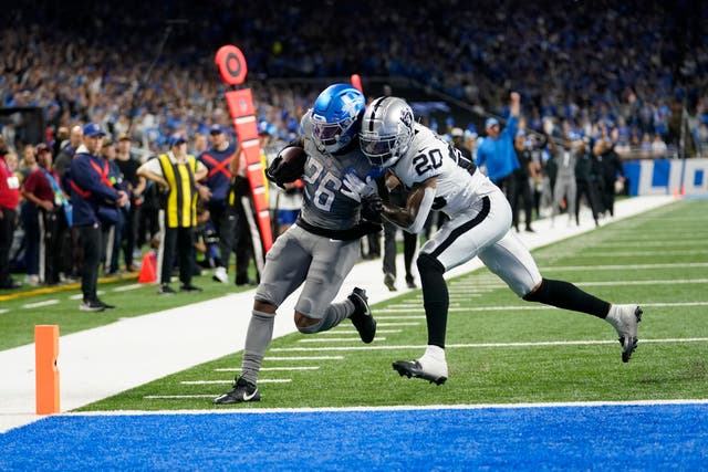 Detroit Lions running back Jahmyr Gibbs is pushed out of bounds by Las Vegas Raiders safety Isaiah Pola-Mao after a 27-yard rushing touchdown (Paul Sancya/AP)