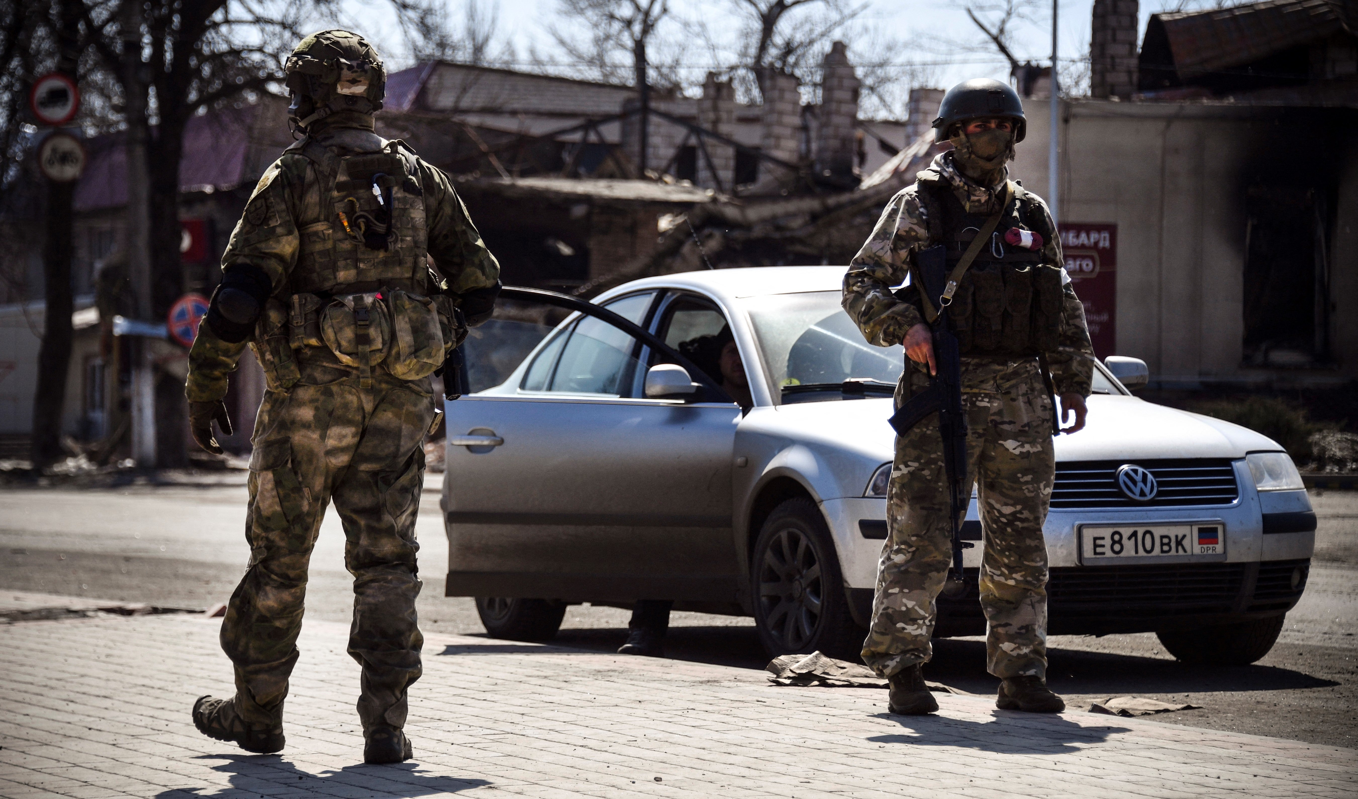 Russian soldiers patrol a street in Volnovakha in the Donetsk region in April 2022