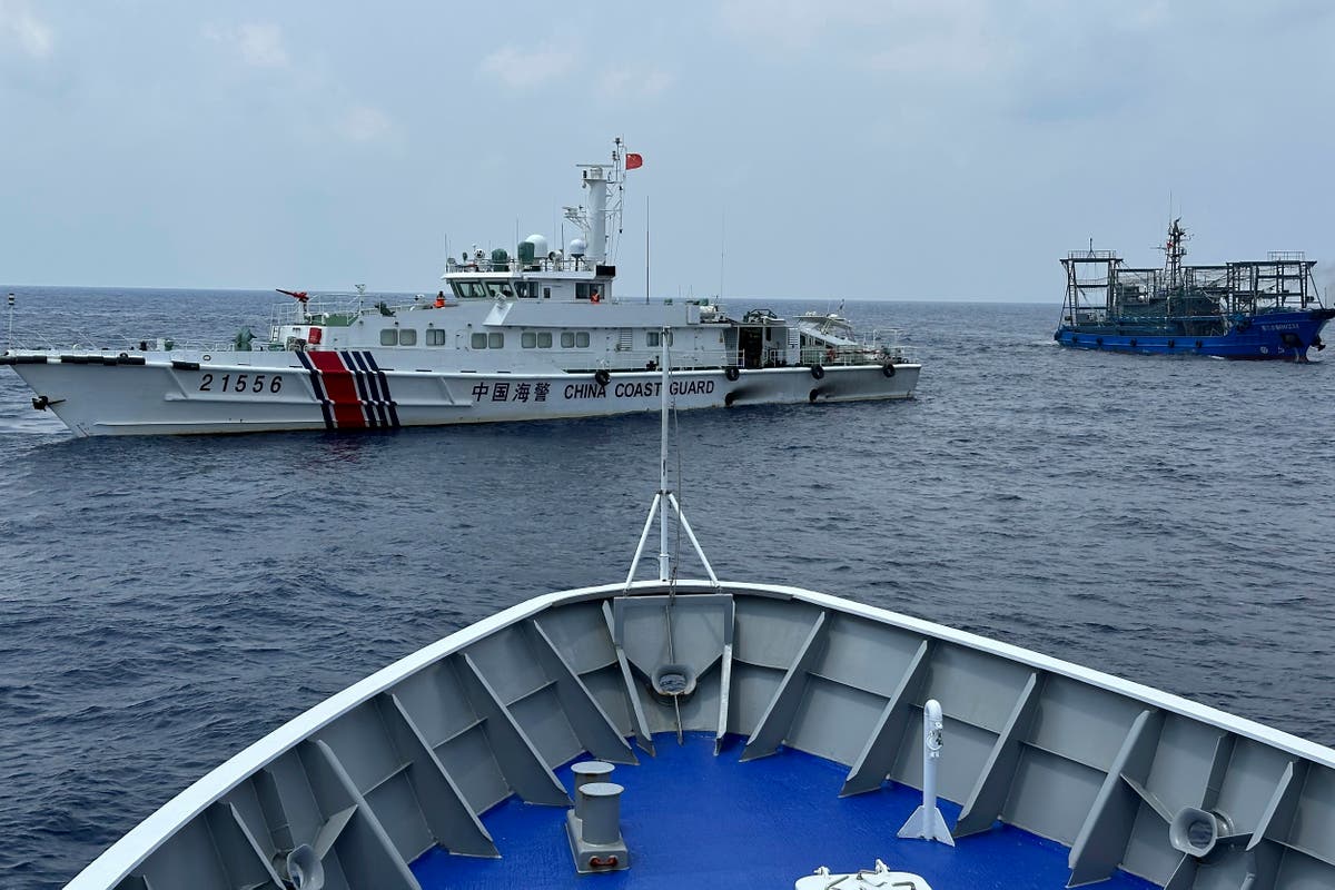 China's forces shadow a Philippine navy ship near disputed shoal, sparking new exchange of warnings
