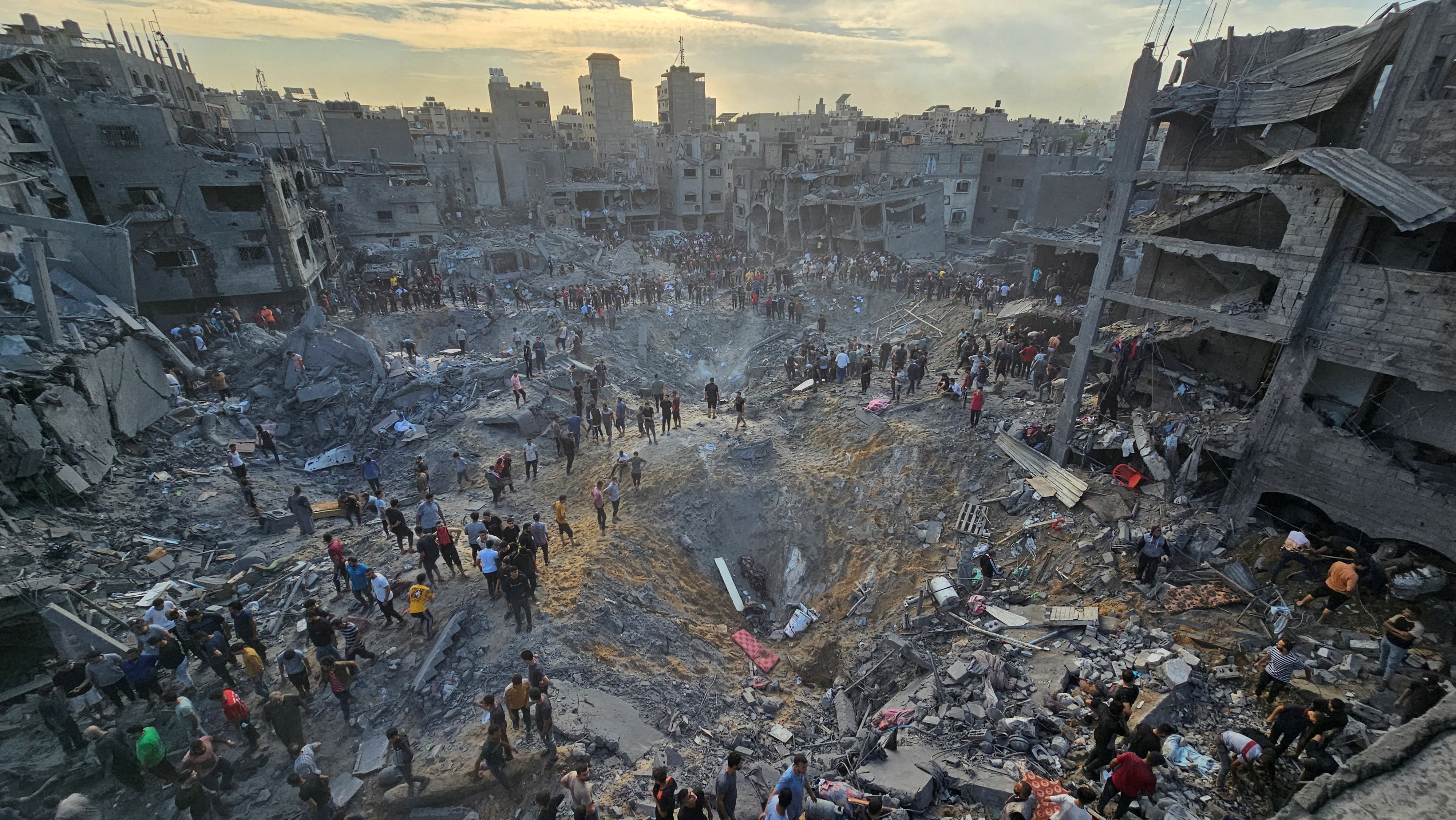 Palestinians search for survivors at the site of Israeli strikes