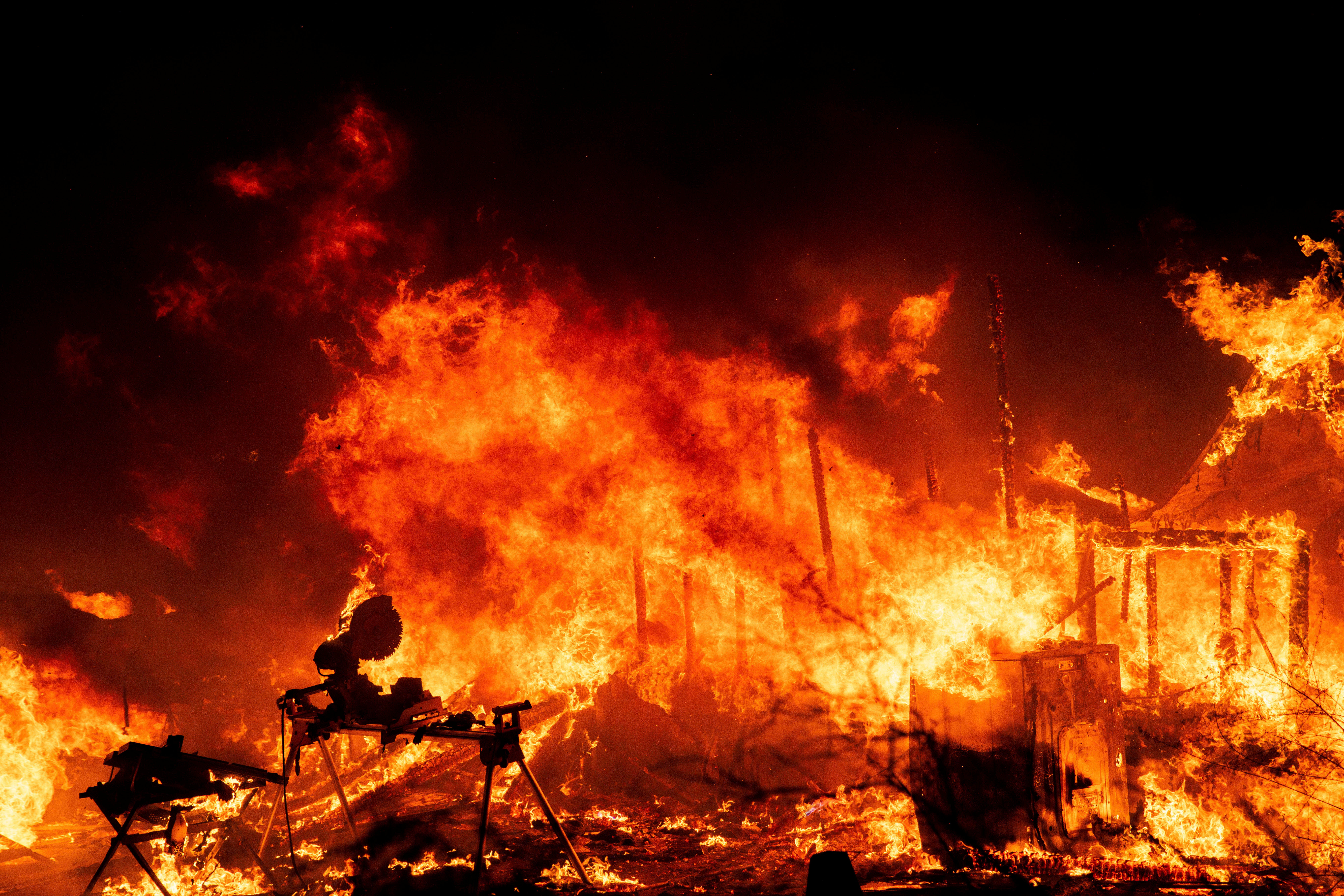 A structure is engulfed in flames as a wildfire called the Highland Fire burns in Aguanga, Calif., Monday, Oct. 30, 2023