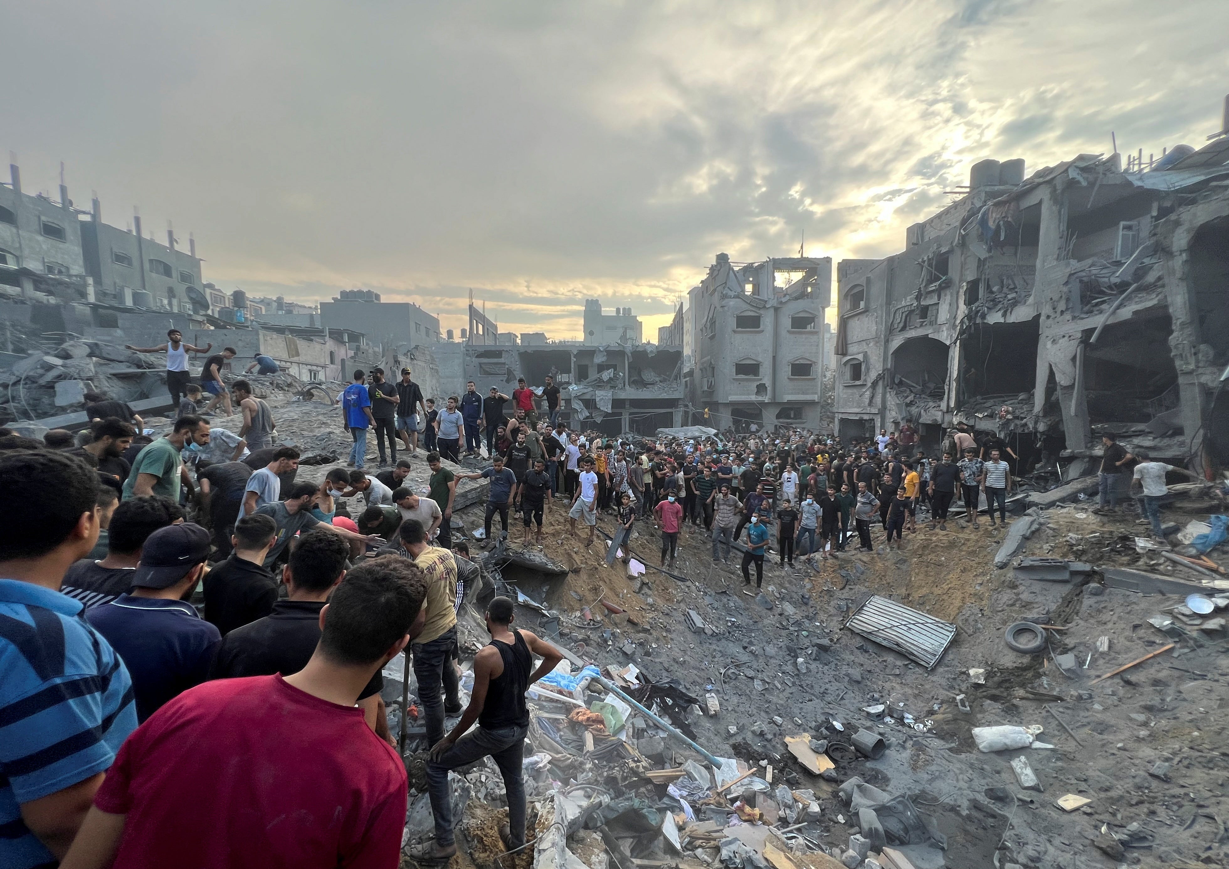 Palestinians search for casualties at the site of Israeli strikes on houses in Jabalia refugee camp in the northern Gaza Strip, October 31, 2023