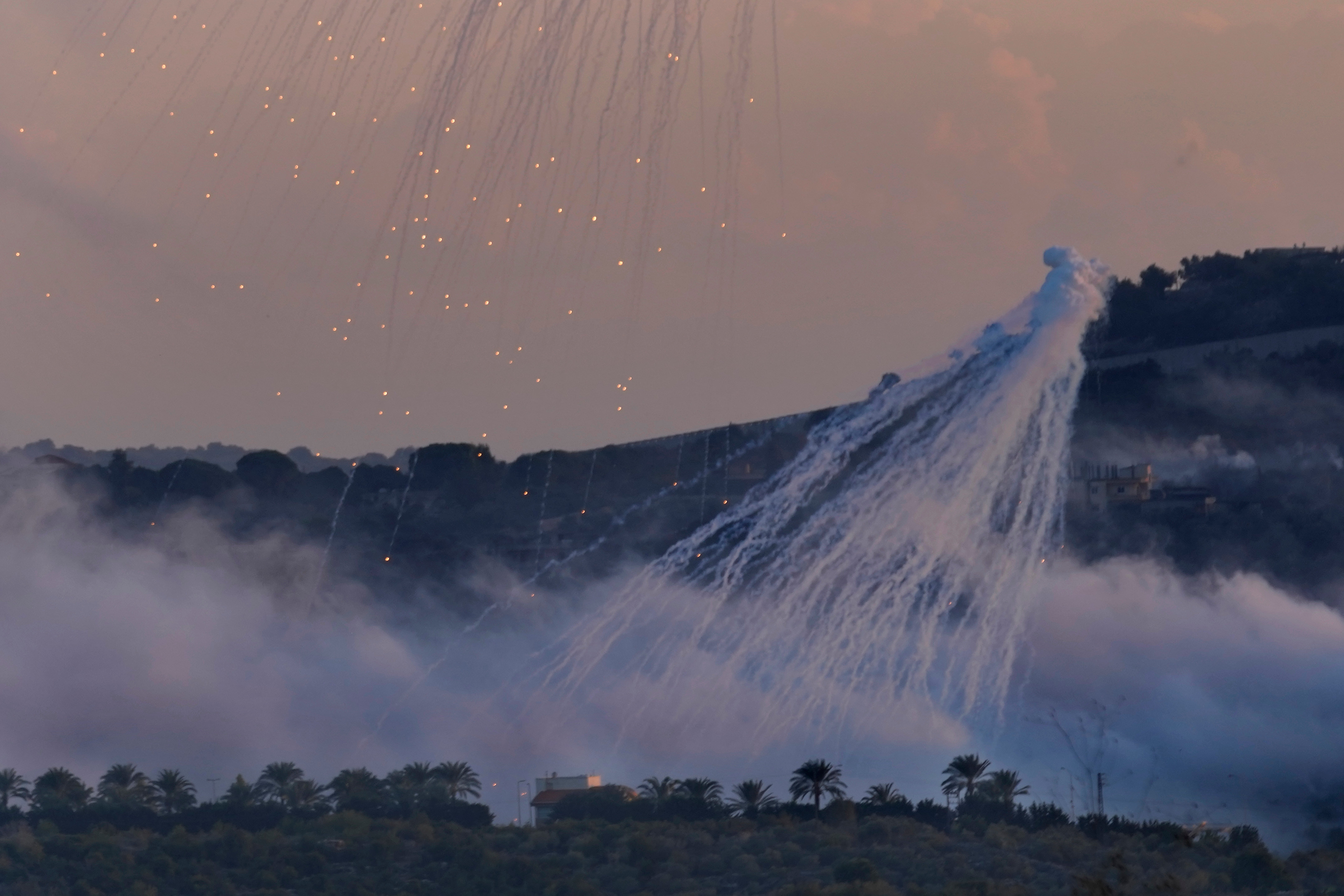 Israel LShells that appears to be white phosphorus from Israeli artillery explode over Dahaira, a Lebanese border village with Israel, south Lebanon, on 16 October