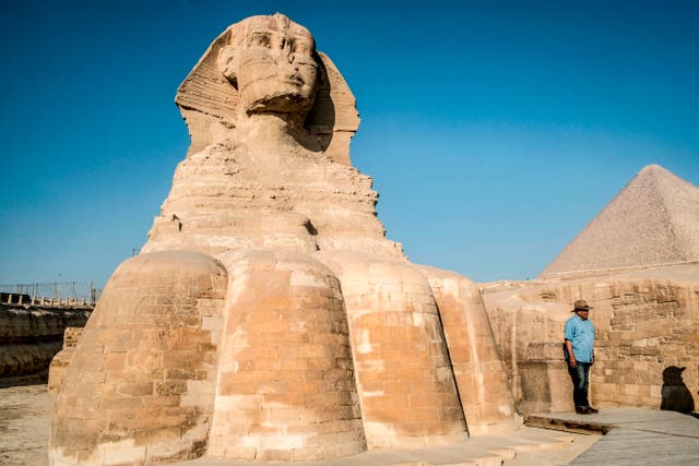 <p>Zahi Hawass, Egyptian archaeologist and former antiquities minister, stands before the Great Sphinx of Giza during a lecture with a tourist group on ancient Egyptian history, at the Giza Necropolis on the southeastern outskirts of the capital on November 20, 2019</p>