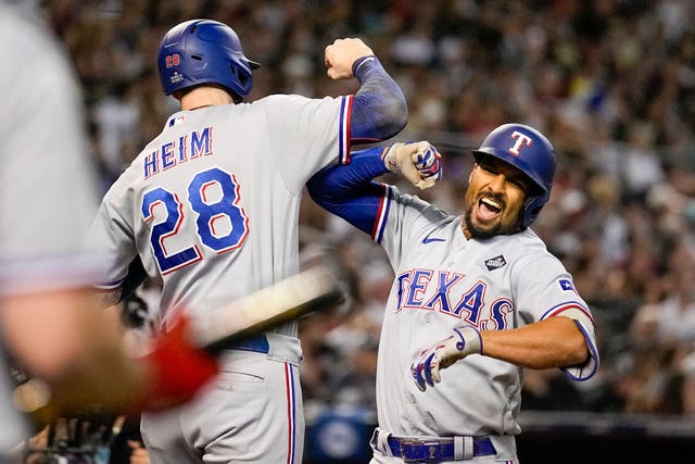 Texas Rangers’ Marcus Semien, right, celebrates his three-run home run with Jonah Heim during the third inning in Game 4 of the baseball World Series against the Arizona Diamondbacks (Brynn Anderson, AP)