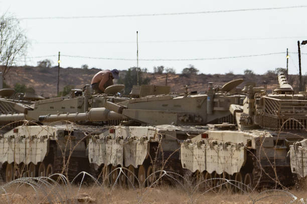 <p>A soldier works on a tank on 31 October 2023 in Southern Israel</p>