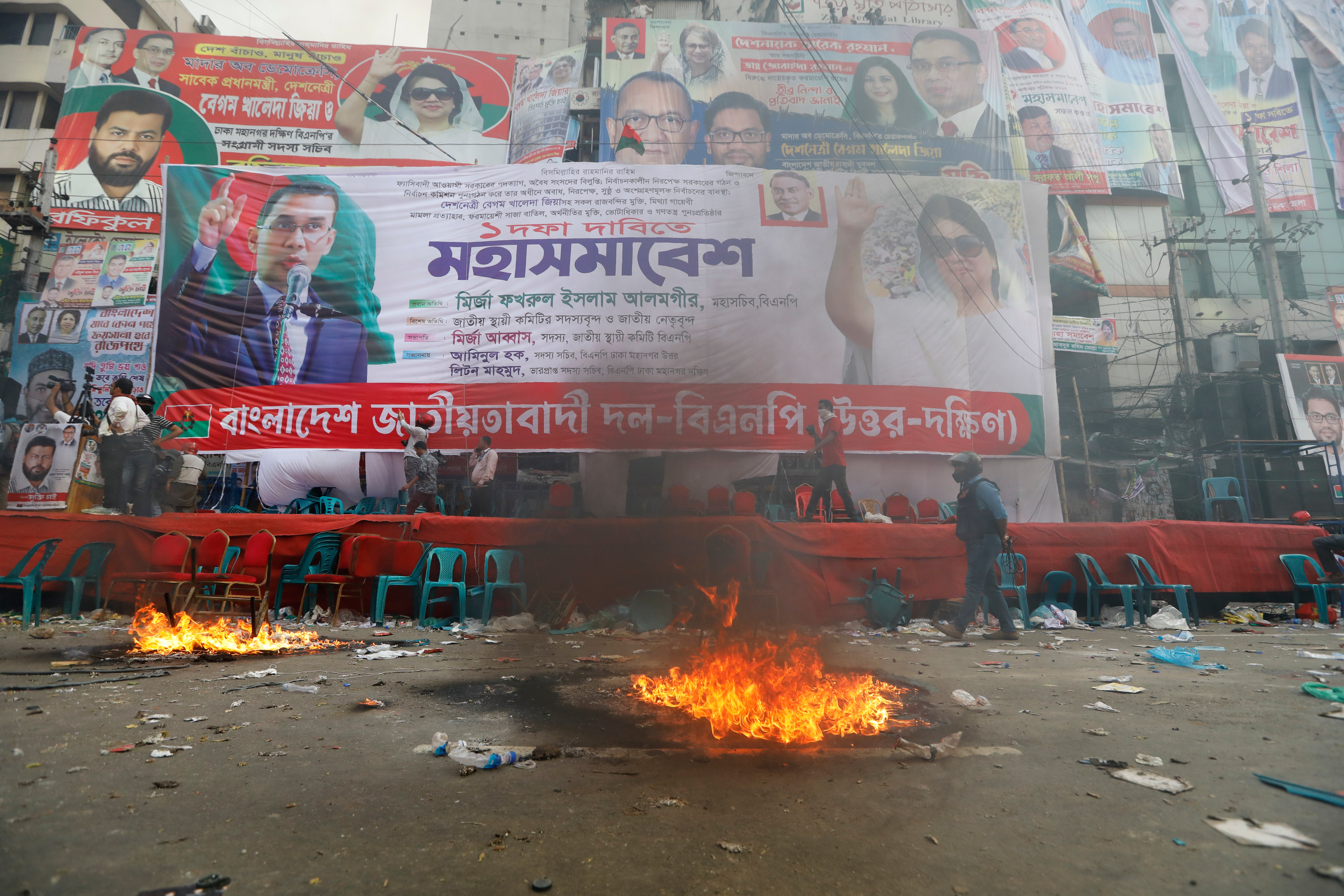 Smoke rises from flames near the stage set for a protest by the Bangladesh Nationalist Party in Dhaka, Bangladesh on 28 October