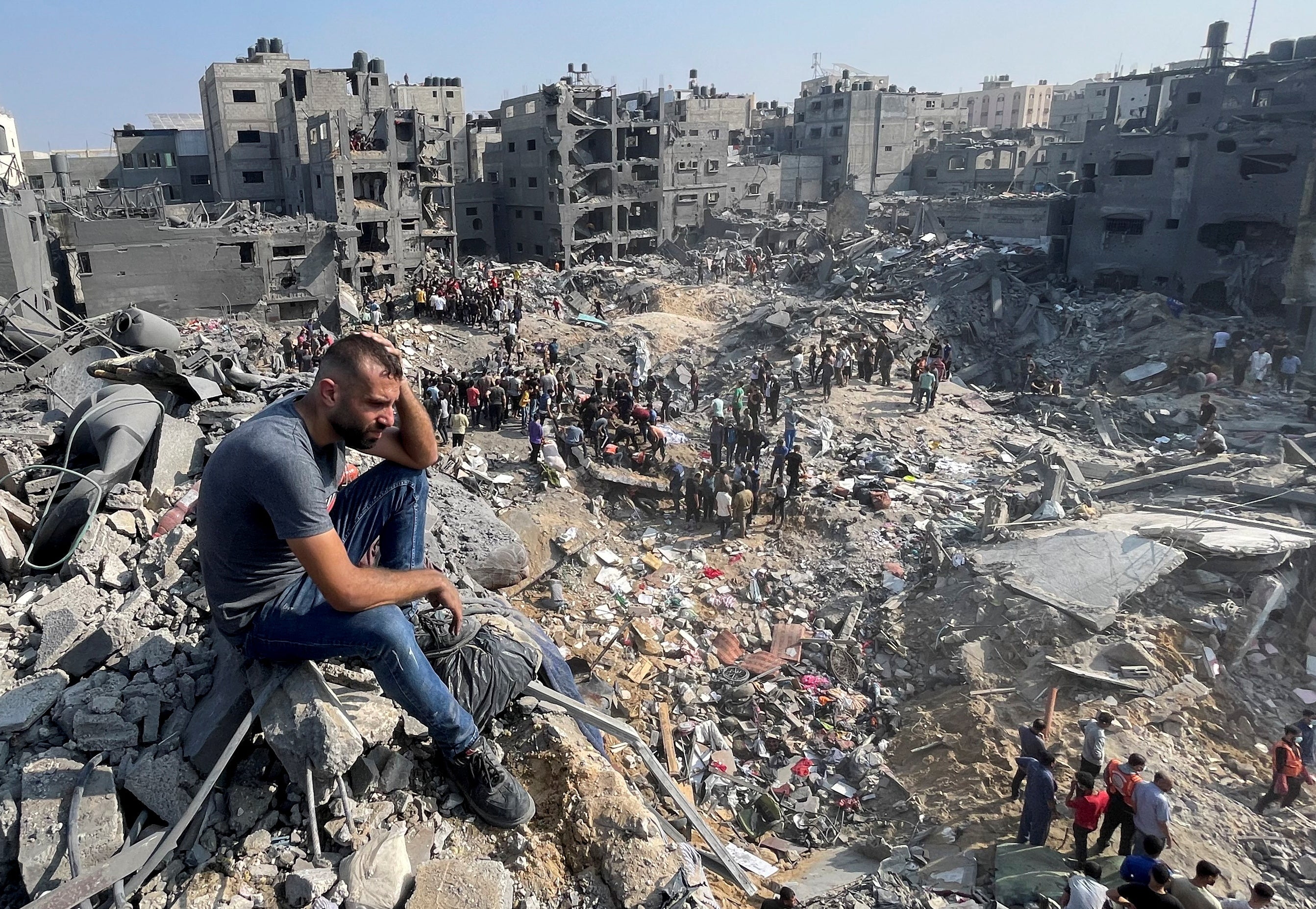 A man gestures as Palestinians search for casualties a day after Israeli strikes on houses in Jabalia refugee camp