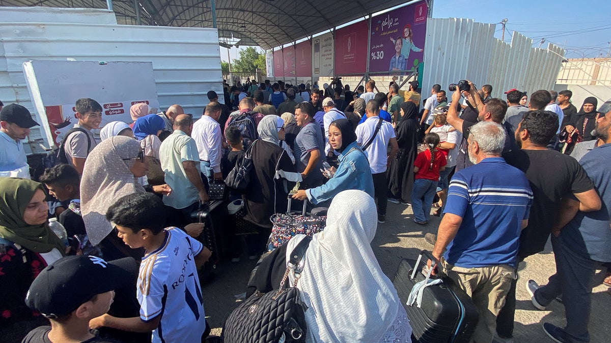 Desperate scenes at Rafah crossing as trapped foreign nationals in dark over whether they can leave Gaza