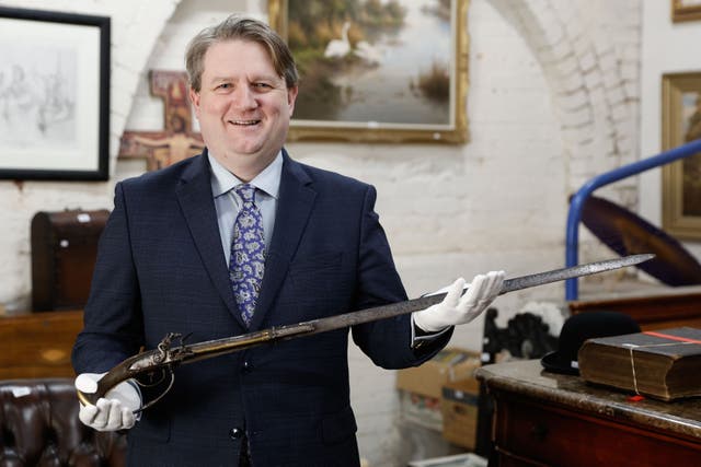 Bloomfield Auctions Managing Director Karl Bennett with a sword pistol linked to the 1689 Siege of Derry (Phil Magowan/Press Eye/PA)
