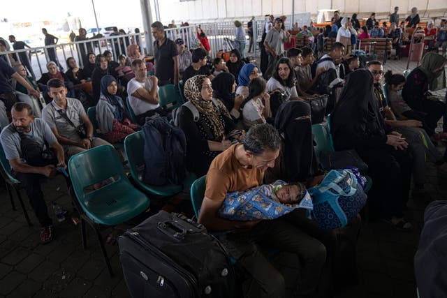 Palestinians wait to cross into Egypt at Rafah, Gaza Strip (Fatima Shbair/AP)