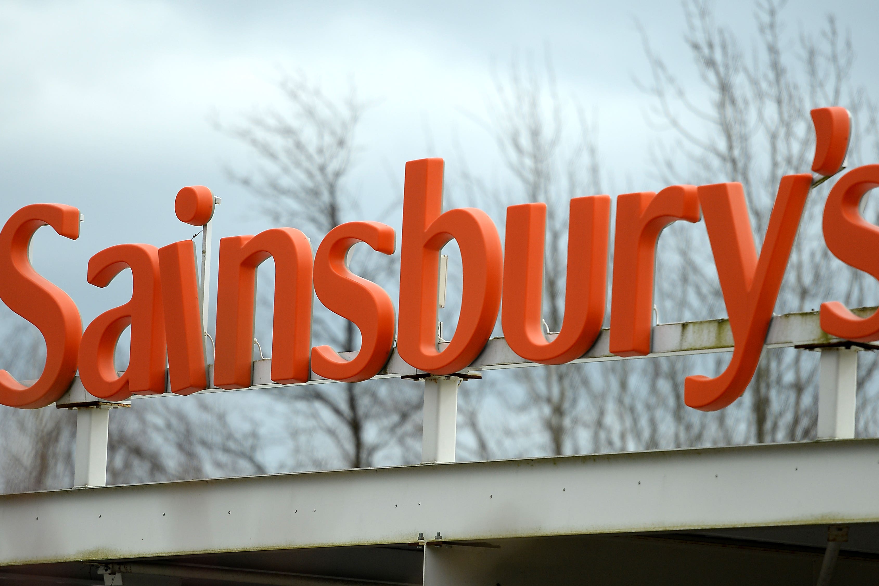 Supermarket giant Sainsbury’s has boosted its earnings outlook thanks to soaring grocery sales as it focused on keeping food costs down for cash-strapped customers (Andrew Matthews/PA)