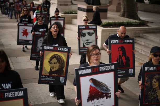 People take part in a protest march through London on the first anniversary of the death of Mahsa Amini, on 13 September 2023 in London, England