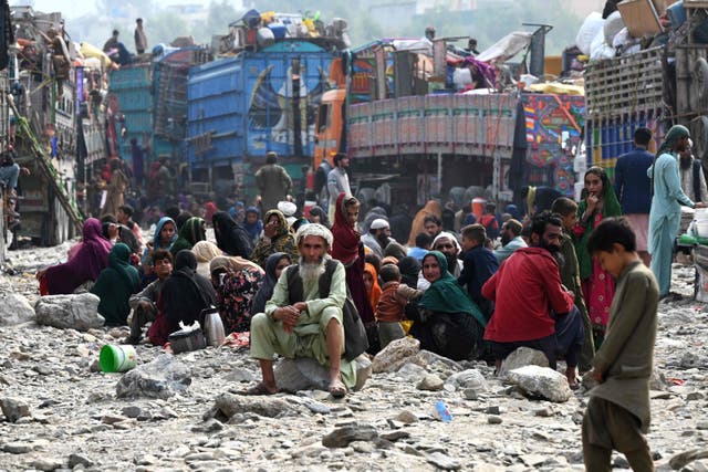 <p>Afghan refugees rest near trucks upon their arrival from Pakistan at the Afghanistan-Pakistan Torkham border in Nangarhar province on November 1, 2023.</p>