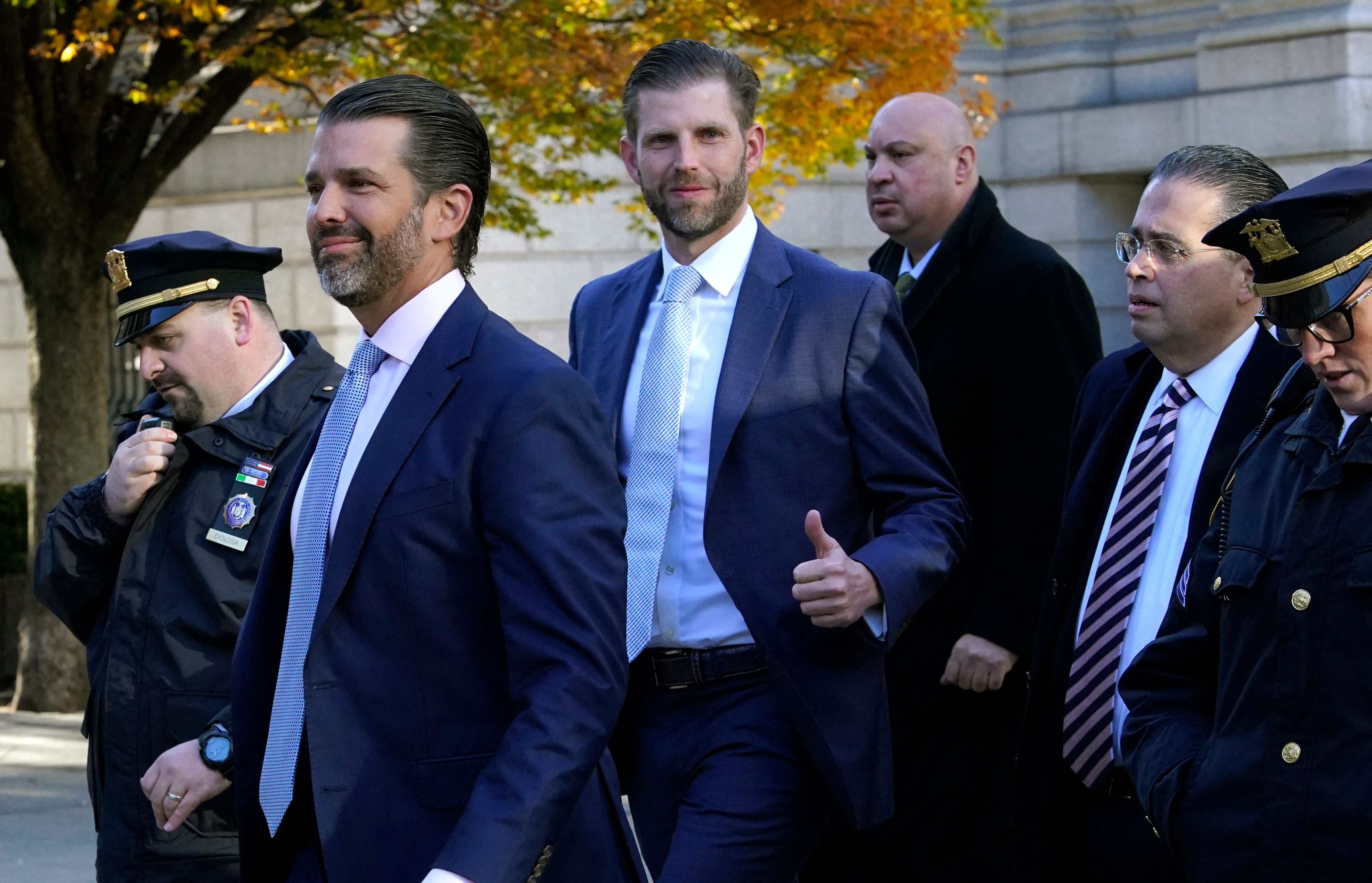 Donald Trump Jr (2nd L) and Eric Trump (3rd L) arrive at New York Supreme Court on 2 November 2023, for the fraud trial of the Trump Organization