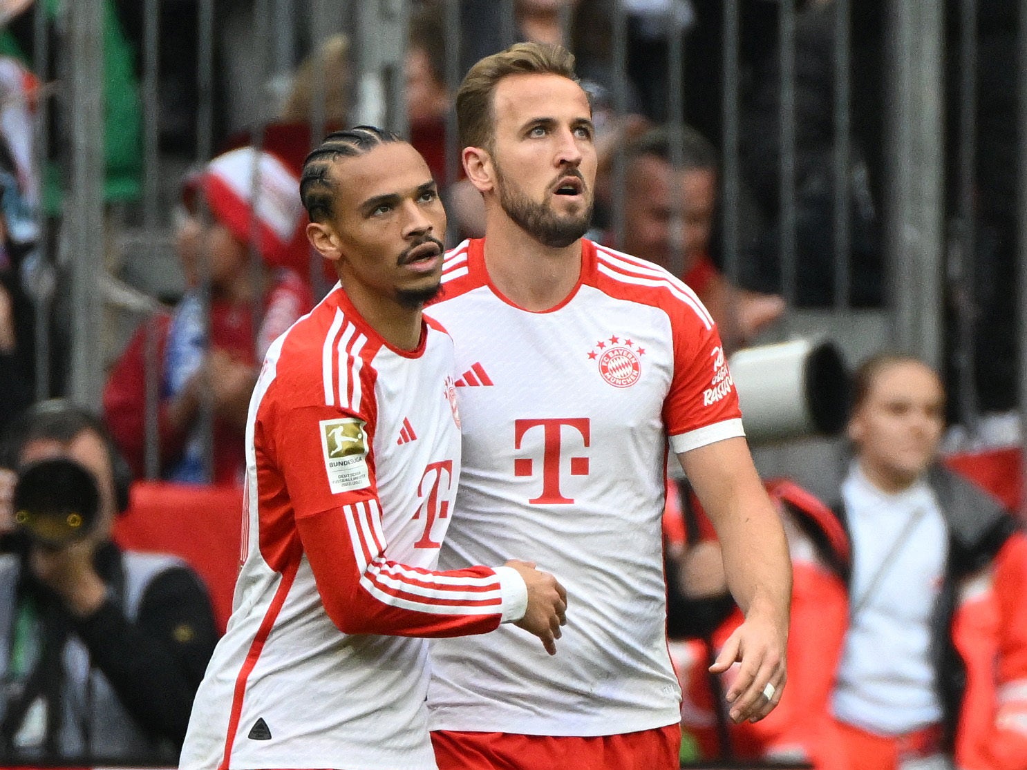Bayern Munich’s Harry Kane celebrates scoring with Leroy Sane