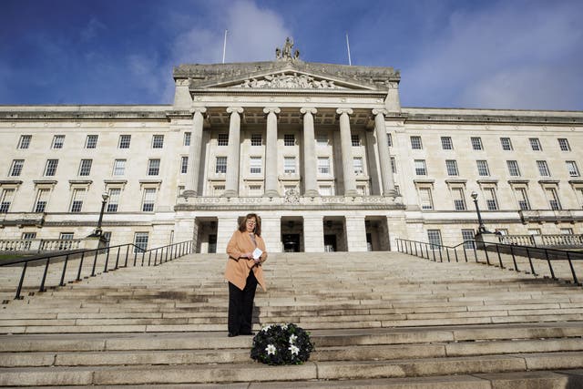 Dympna Kerr, the sister of Columba McVeigh, lays the wreath during the 17th annual All Souls Silent Walk for the Disappeared at Stormont (Liam McBurney/PA)