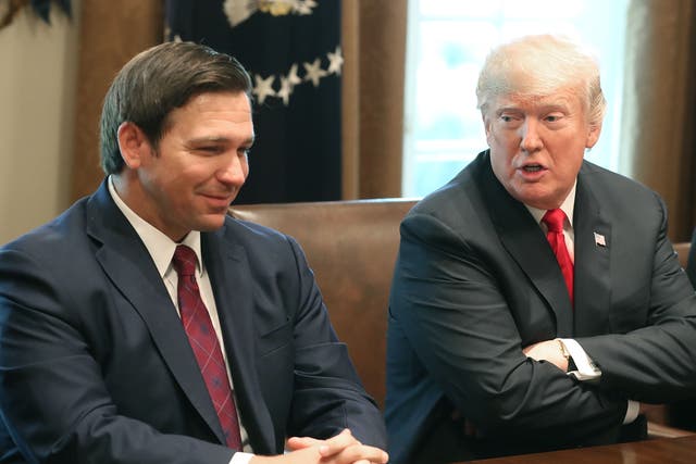 <p>Florida Governor-elect Ron DeSantis (R) sits next to U.S. President Donald Trump during a meeting with Governors elects in the Cabinet Room at the White House on December 13, 2018 in Washington, DC</p>