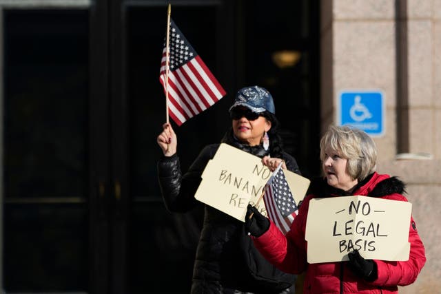 <p>Trump supporters hold signs outside the Minnesota Judicial Center, Thursday, Nov. 2, 2023, in St. Paul, Minn. Efforts to use the Constitution's "insurrection" clause to prevent former President Donald Trump from running again for the White House turn to Minnesota </p>
