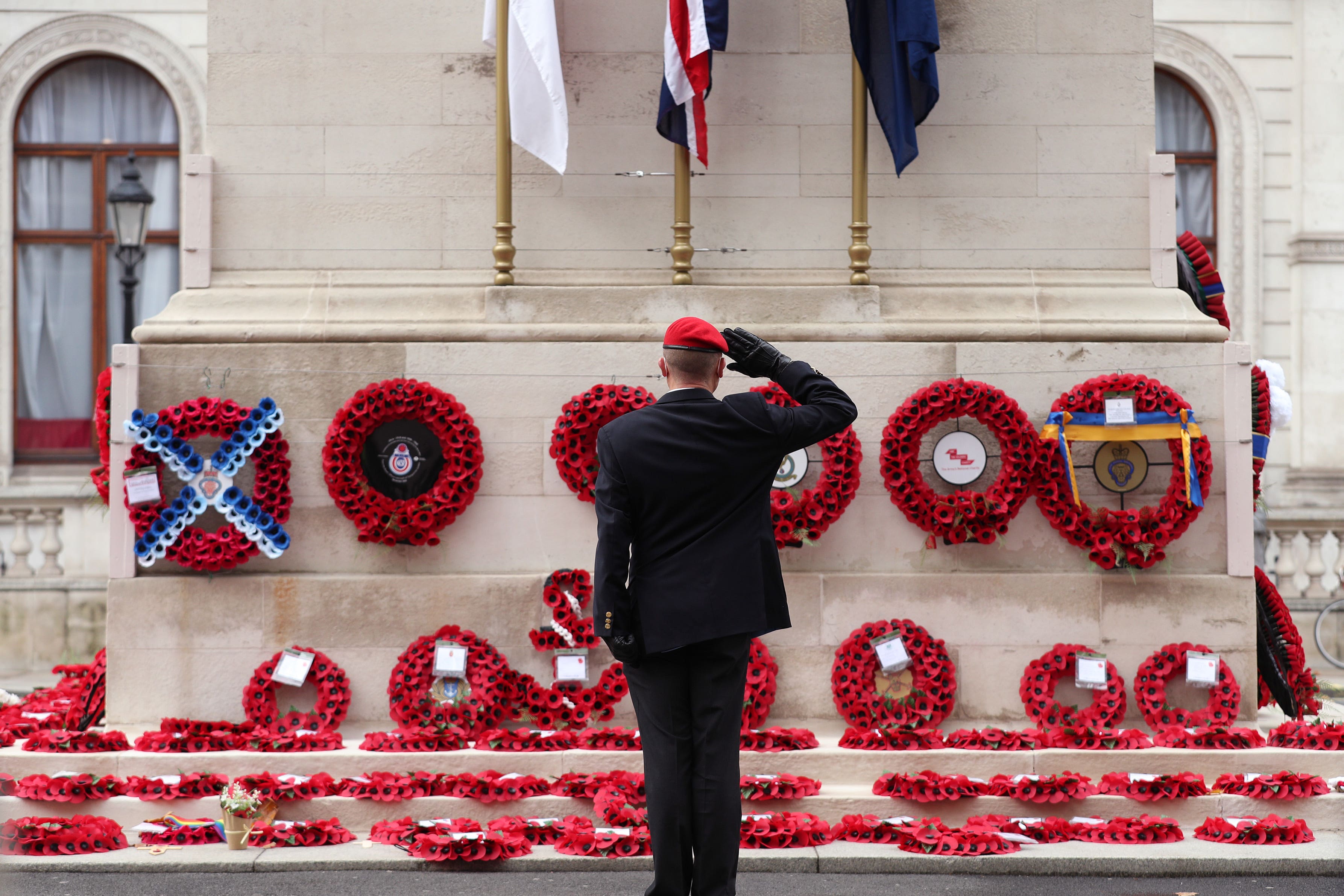 A member of the armed services gives a salute at the Cenotaph on Whitehall on Armistice Day 2020