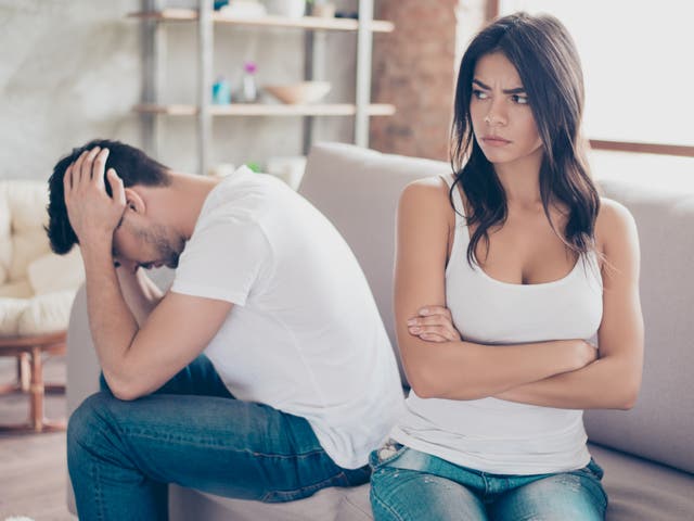 <p> Annoyed couple is ignoring each other, sitting on the couch upset indoors at home. </p>
