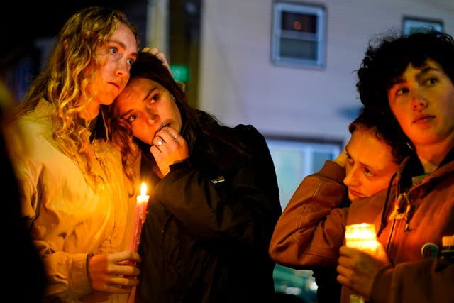 <p>People linger after a vigil for the victims of Wednesday’s mass shootings, Sunday, Oct. 29, 2023</p>