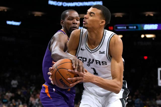 Phoenix Suns forward Kevin Durant fouls San Antonio Spurs centre Victor Wembanyama (Rick Scuteri/ AP)
