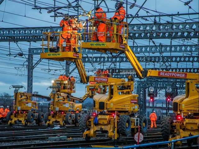 <p>Power problems: Network Rail engineers repairing overhead line equipment </p>