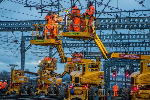 <p>Power problems: Network Rail engineers repairing overhead line equipment </p>