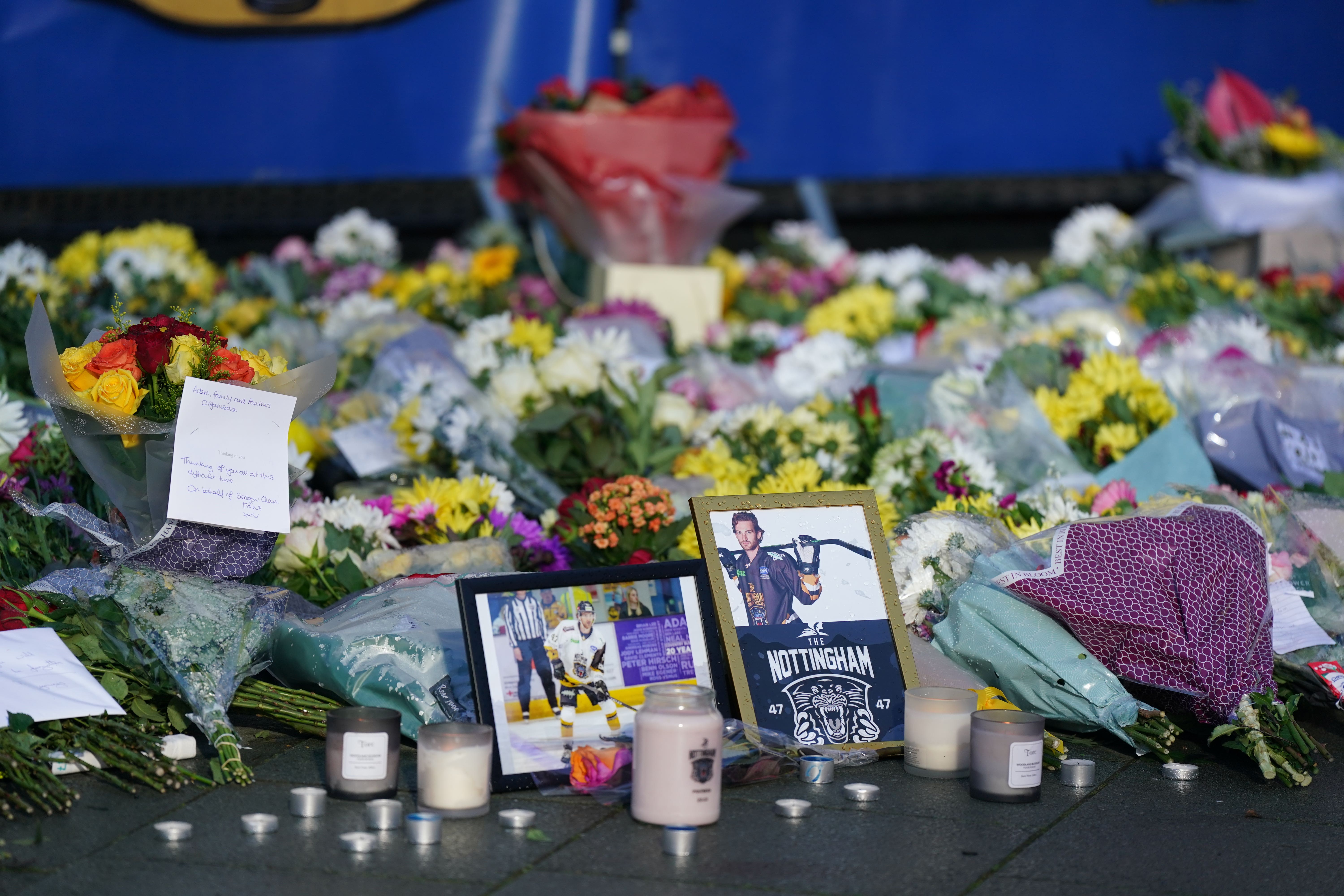 Lit candles among the flowers and messages left in tribute to Nottingham Panthers’ ice hockey player Adam Johnson outside the Motorpoint Arena in Nottingham