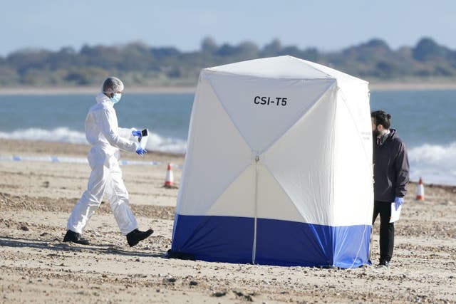 Police officers on the beach off Eastern Parade in Southsea, Hampshire, where a man’s body was found (Andrew Matthews/PA)