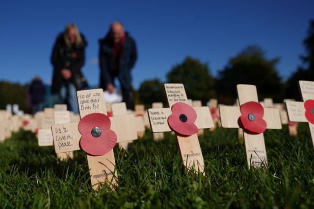 People view tributes at the official opening of the 2023 Royal British Legion Field of Remembrance (Joe Giddens/PA)