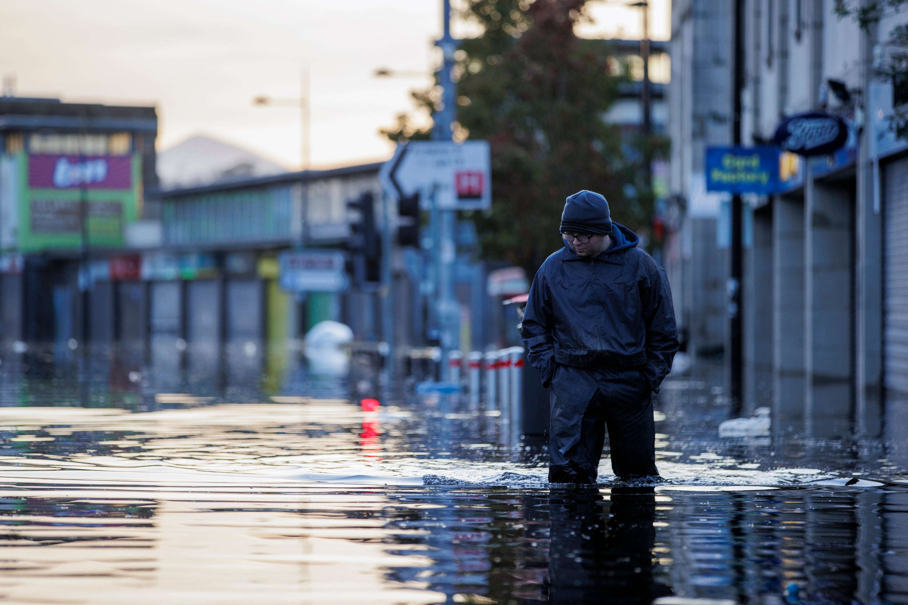 Michael McShane walks through flood water on Market Street in Downpatrick