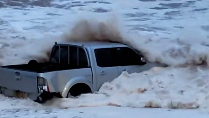 Sea spits mangled 4x4 truck out onto Devon beach