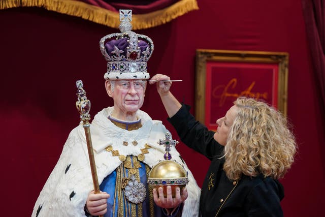 The finishing touches are applied to a life-sized cake figure of King Charles (Jacob King/PA)